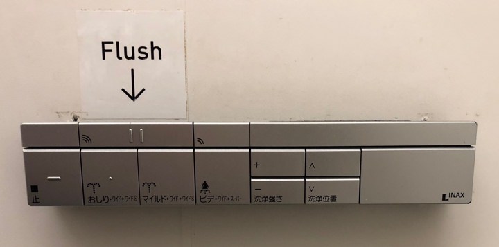 Toilet interface with clearly marked flush button