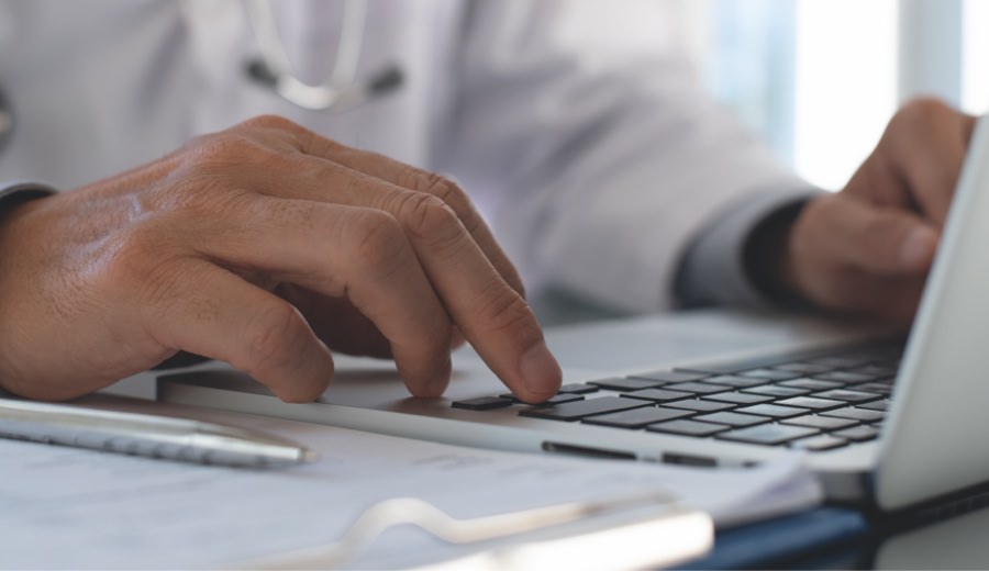 A doctor using a laptop