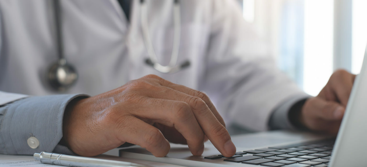 Doctor using a laptop computer