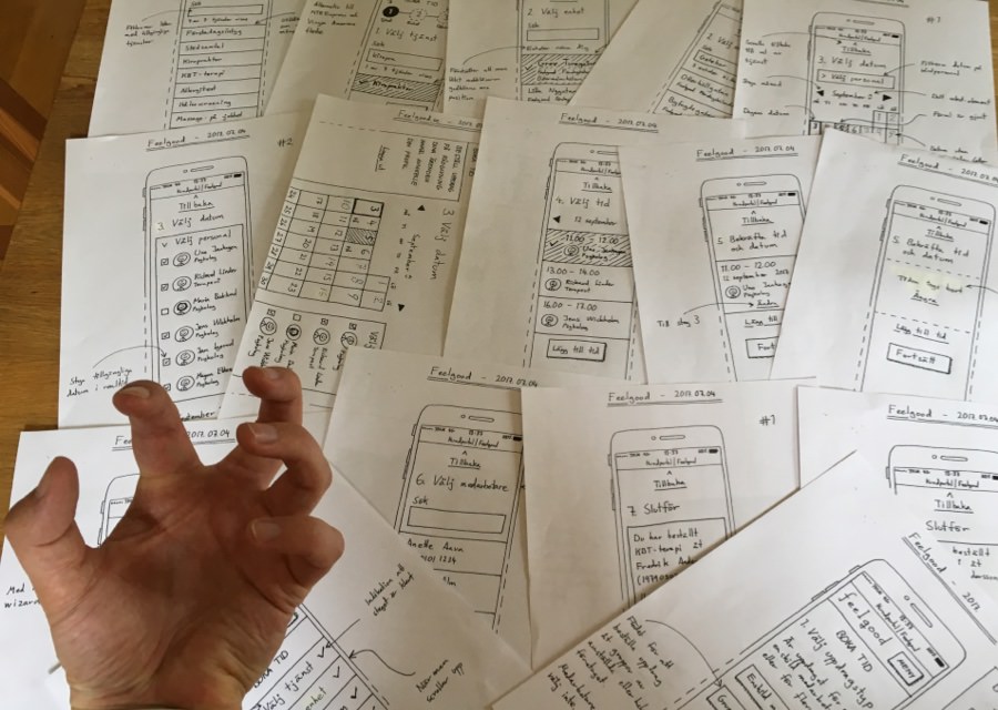 Photograph of a lot of paper wireframes on a table.